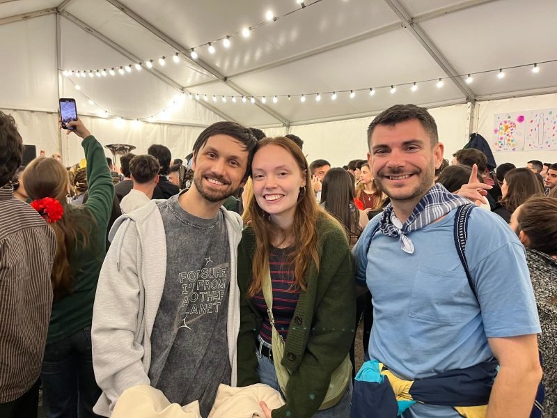 Héctor with students at a festival under string lights